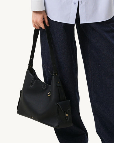 Onyx Grain Medium Yore Hobo Bag in textured leather with gold hardware, worn on shoulder.