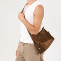 Medium Yore Hobo Bag in Sandal Suede with leather accents, worn by a model.