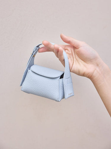 Sky Mini Drippy AirPods Case made of full-grain leather with stainless steel hardware