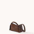 Mini Drippy Roof Bag in chocolate brown textured leather with white stitching and top handle.