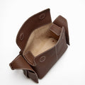 Brown pebbled leather Mini Drippy Roof Bag with white stitching, open top, tan interior. Modern design inspired by Chinese architecture.