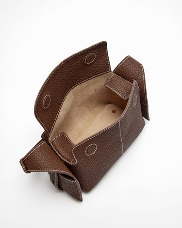 Brown pebbled leather Mini Drippy Roof Bag with white stitching, open top, tan interior. Modern design inspired by Chinese architecture.