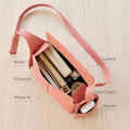 Pink textured leather Mini Drippy Roof Bag, organized interior with wallet, iPhone 15, notebook, lipstick, hand cream, AirPods.