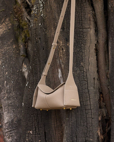 Mini Drippy Roof Bag in cobble textured leather, showcasing its structured yet soft design and gold hardware accents.