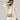 Pebbled leather Mini Drippy Roof Bag in Cobble, crossbody style with gold hardware, worn with a linen outfit.