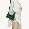 Emerald Mini Drippy Roof Bag crafted from textured leather, featuring a structured silhouette and subtle gold hardware.