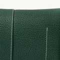 Mini Drippy Roof Bag in emerald green pebbled leather with white contrast stitching. Architectural design.