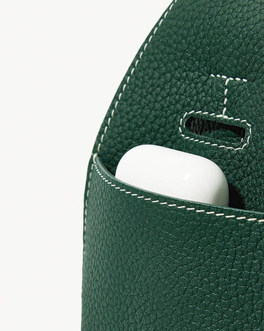 Mini Drippy Roof Bag in emerald green leather, showing a pocket with a white earbud case.
