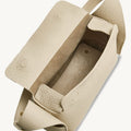 Mini Drippy Roof Bag in ivory textured leather, open to reveal microfiber lining and interior compartment.