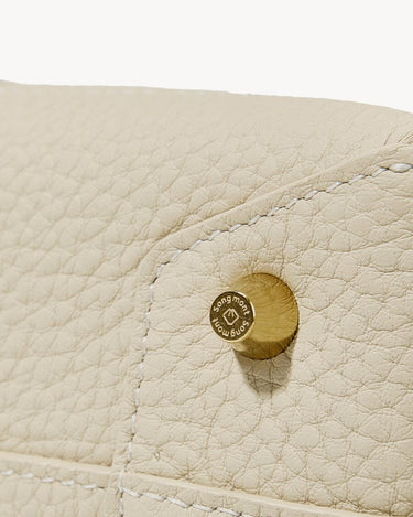 Ivory Mini Drippy Roof Bag close-up: textured leather, stitching, and engraved songmont logo hardware.