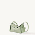 Sage green full-grain leather mini drippy roof bag with stainless steel hardware and adjustable strap.