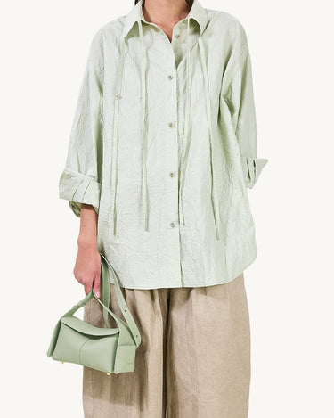 Mini Drippy Roof Bag in light green full-grain leather with gold hardware.