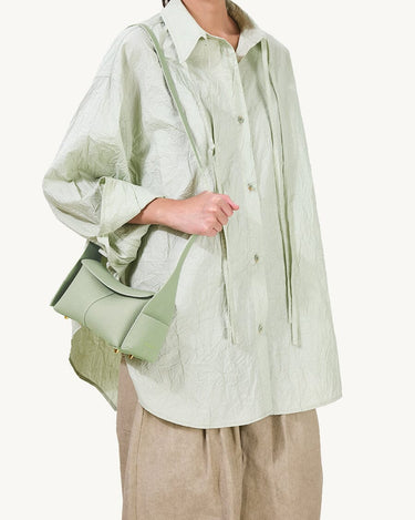 Mini Drippy Roof Bag in light green full-grain leather with flap closure and gold hardware.