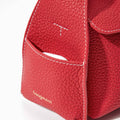 Red full-grain leather mini bag with white stitching and gold 'Songmont' logo. Features exterior pocket.