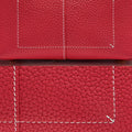 Red full-grain leather mini drippy roof bag with white contrast stitching