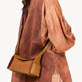 Mini Drippy Roof Bag in tan nubuck leather with adjustable strap. Modern Eastern aesthetic with architectural inspiration.