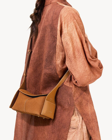 Mini Drippy Roof Bag in tan nubuck leather with adjustable strap. Modern Eastern aesthetic with architectural inspiration.