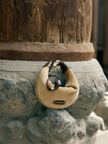 Tan suede Mini Luna AirPods case with dark brown leather accents and gold hardware, featuring 'songmont' logo.
