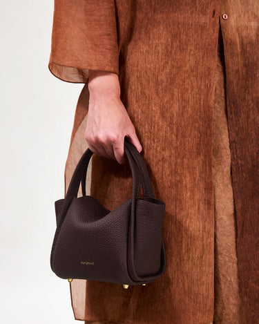 Burgundy Mini Song Bag with pebbled leather texture and gold hardware.