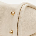 Ivory Mini Song Bag with textured full-grain leather and embossed gold feet.