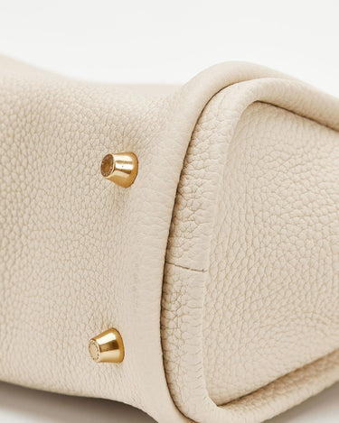 Ivory Mini Song Bag with textured full-grain leather and embossed gold feet.