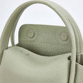 Jade Mini Song Bag with textured full-grain leather and visible stitching. Features structured opening and snap closures.