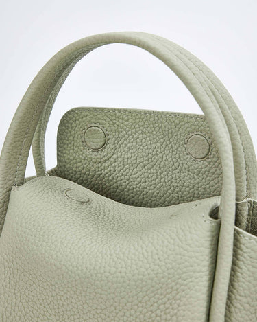 Jade Mini Song Bag with textured full-grain leather and visible stitching. Features structured opening and snap closures.