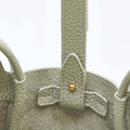 Jade green Mini Song Bag, textured leather, gold stud closure, compact design for spring/summer.