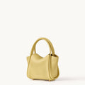 Mini Song Bag in lemon yellow pebbled full-grain leather with folded sides and dual top handles.