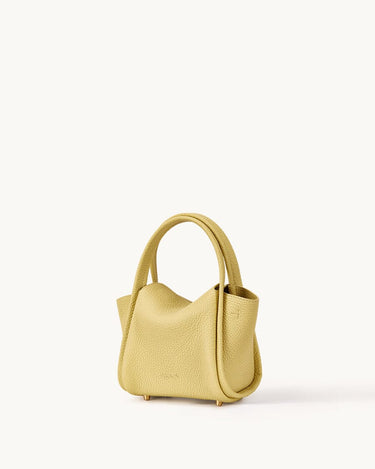 Mini Song Bag in lemon yellow pebbled full-grain leather with folded sides and dual top handles.