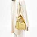 Lemon yellow textured leather Mini Song Bag with gold hardware and adjustable strap.