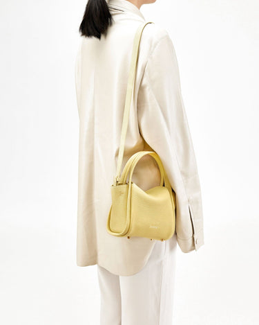 Lemon yellow textured leather Mini Song Bag with gold hardware and adjustable strap.