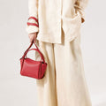 Mini Song Bag in Lucky Red textured leather, with gold hardware. Stylish seasonal bucket bag.
