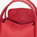 Red pebbled leather Mini Song Bag interior with snap closures and top handles