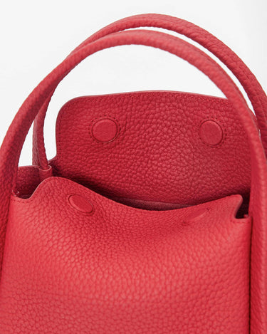 Red pebbled leather Mini Song Bag interior with snap closures and top handles
