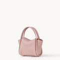 Pink Mini Song Bag made of full-grain leather with gold hardware and adjustable strap