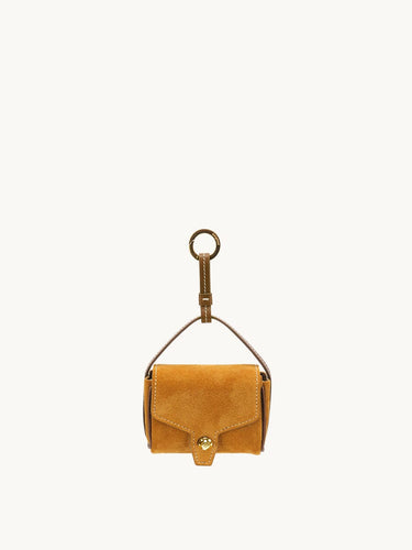 Ochre Mini Yore AirPods Case made of suede with a gold-tone clasp and keychain attachment.