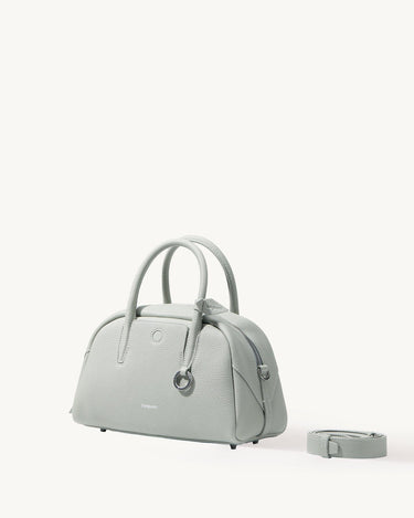 Mini Yore Bowling Bag in Celeste pebble-grain leather with rolled handles and detachable strap.