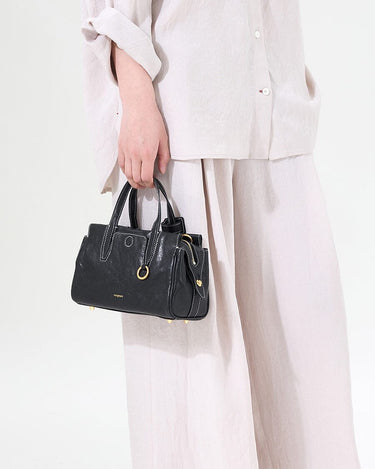 Mini Yore Duffle Bag in Onyx, vegetable-tanned leather with white stitching, ideal for travel and everyday use.