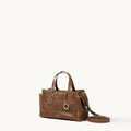 Mini Yore Duffle Bag in Sandal leather, vegetable-tanned, with white stitching and gold hardware.