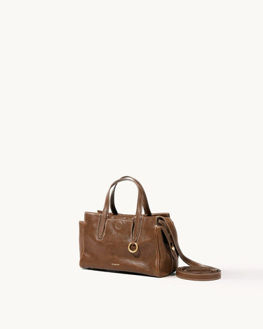 Mini Yore Duffle Bag in Sandal leather, vegetable-tanned, with white stitching and gold hardware.