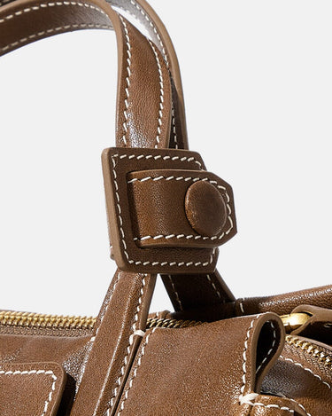 Mini Yore Duffle Bag in Sandal brown leather with detailed white stitching and stud closure