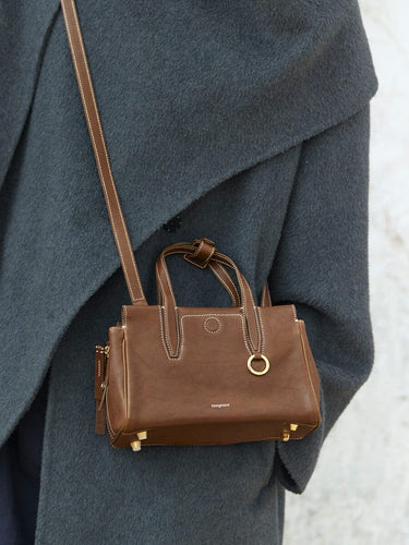 Mini Yore Duffle Bag in Sandal color, featuring vegetable-tanned leather, gold hardware, and white stitching.