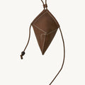 Brown leather Prism Airpods Case with white stitching and braided strap