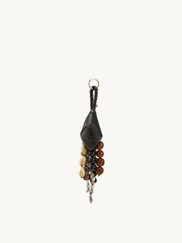 Prism Seed Charm keychain with black leather accent and a cluster of natural seed beads in various earthy tones.