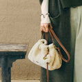 Shearling Gather Clutch Set in amber, featuring fluffy wool and leather details.