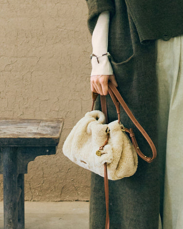 Shearling Gather Clutch Set in amber, featuring fluffy wool and leather details.