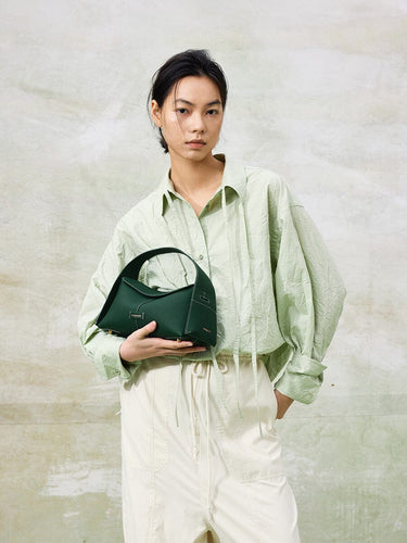 Small Drippy Roof Bag in deep green full-grain leather with microfiber lining and stainless steel hardware.