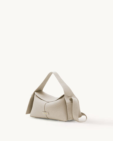 Small Drippy Roof Bag in Ivory pebble-grain leather with adjustable strap and metallic logo detail.