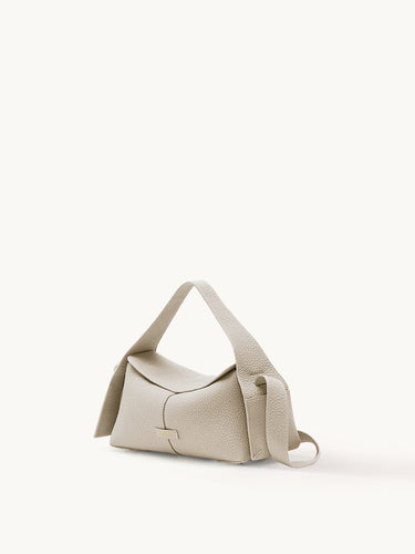Small Drippy Roof Bag in Ivory pebble-grain leather with adjustable strap and metallic logo detail.